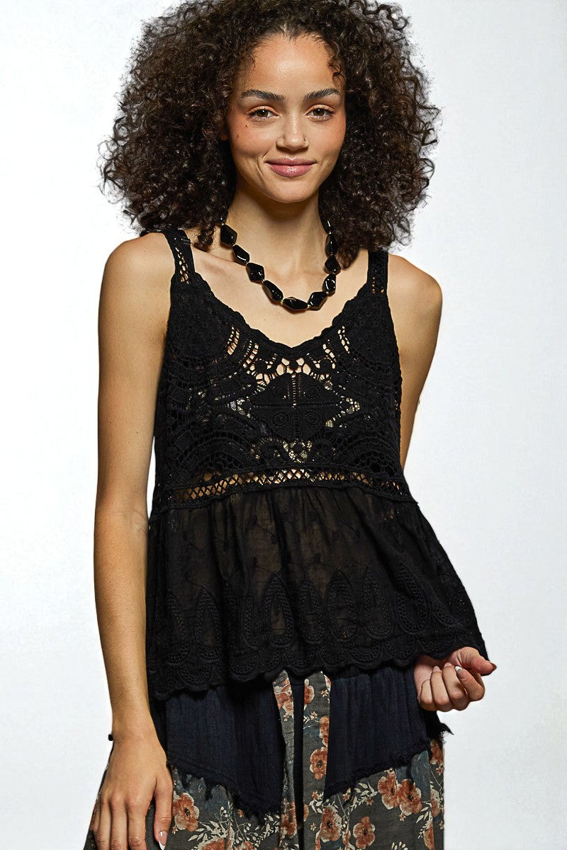 Woman wearing a black lace top with a white background