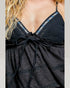 Black dress with blue embellishments on a plain background