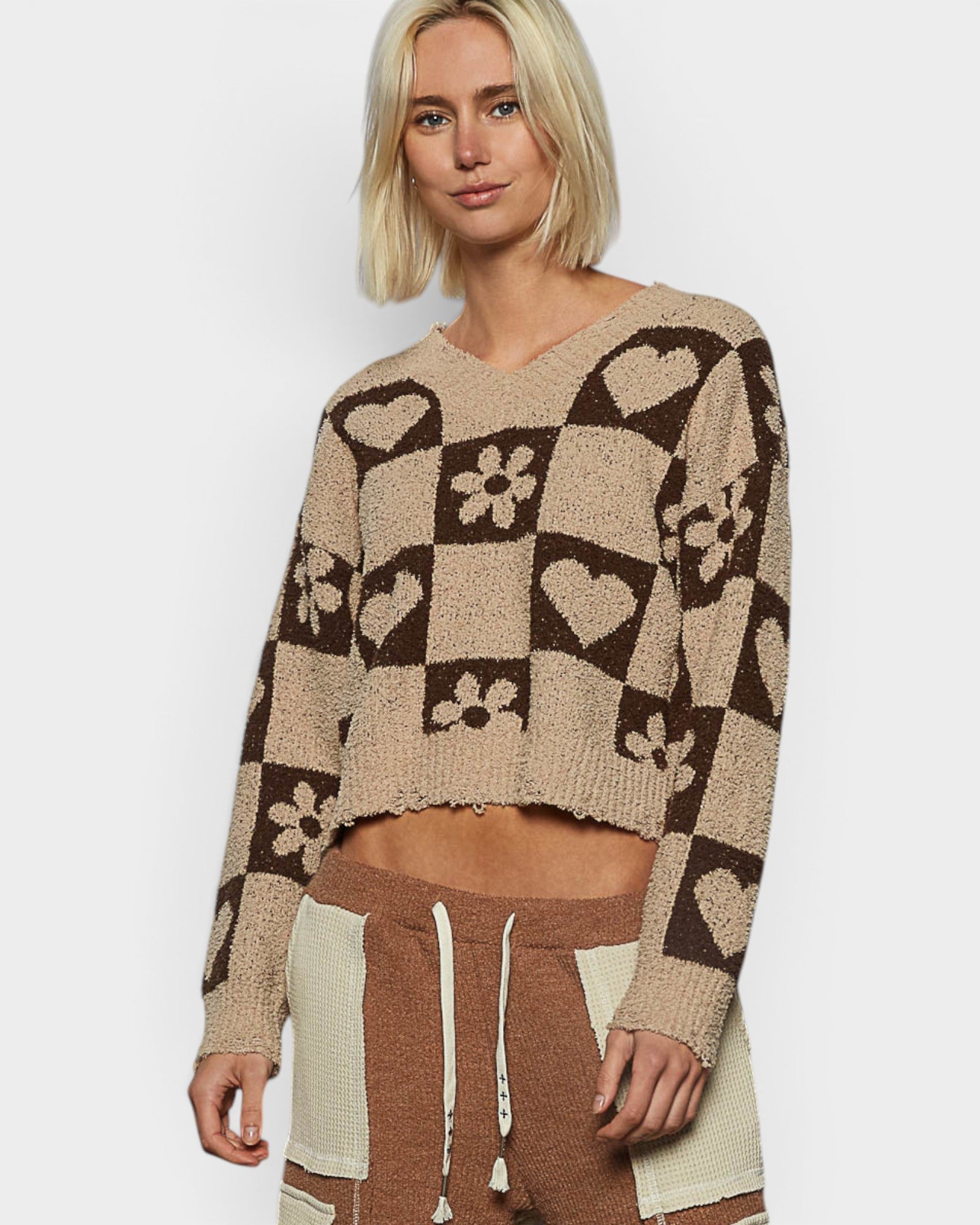 Woman wearing a patterned sweater with a white background