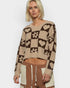 Woman wearing a patterned sweater with a white background