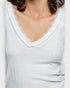 Light gray ribbed sweater with lace trim neckline on a white background