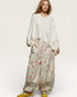 Woman wearing a floral outfit with a white background