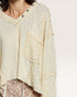 Close-up of a beige textured blouse with a pocket on a white background