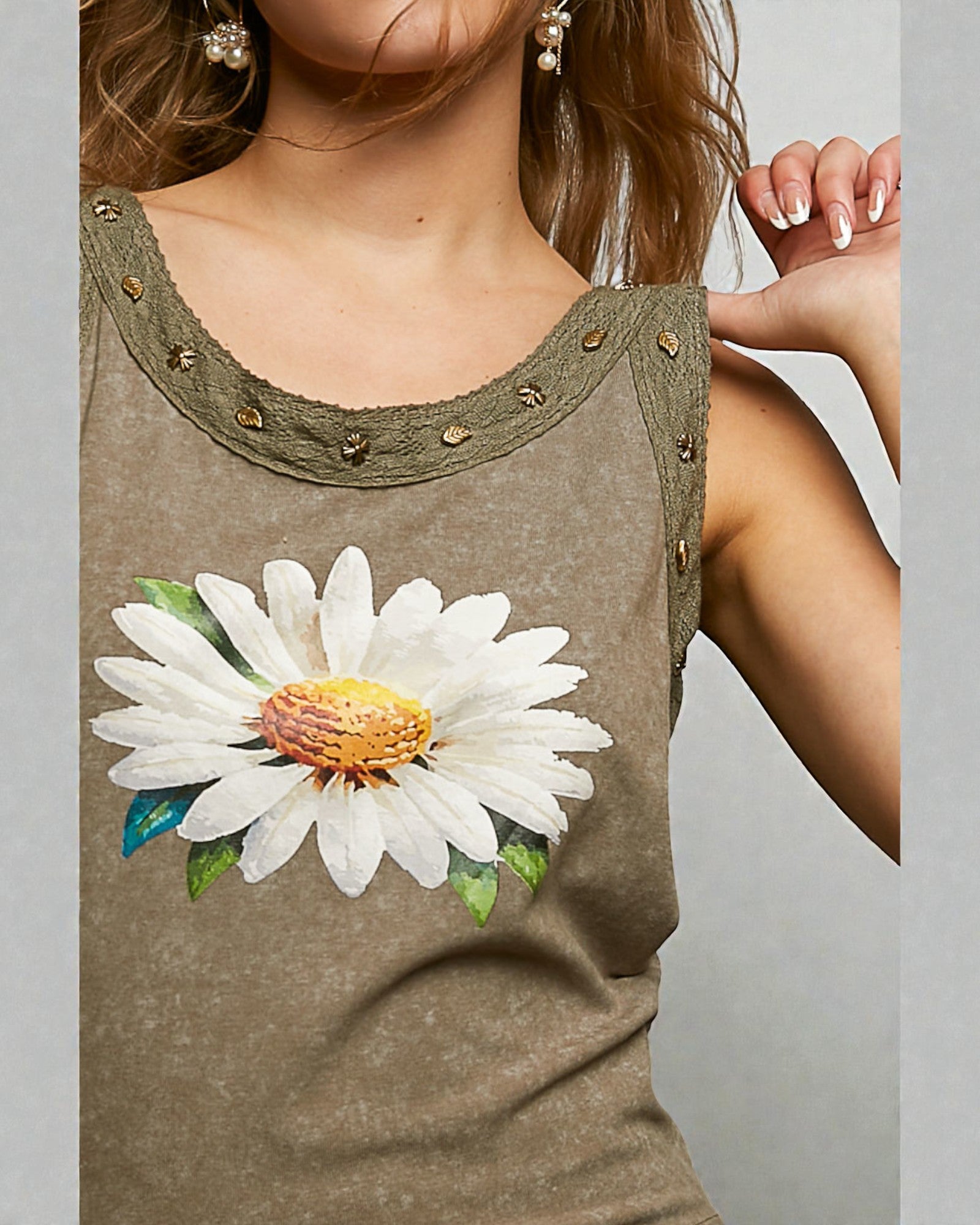 Brown tank top with a large white flower design on a plain background