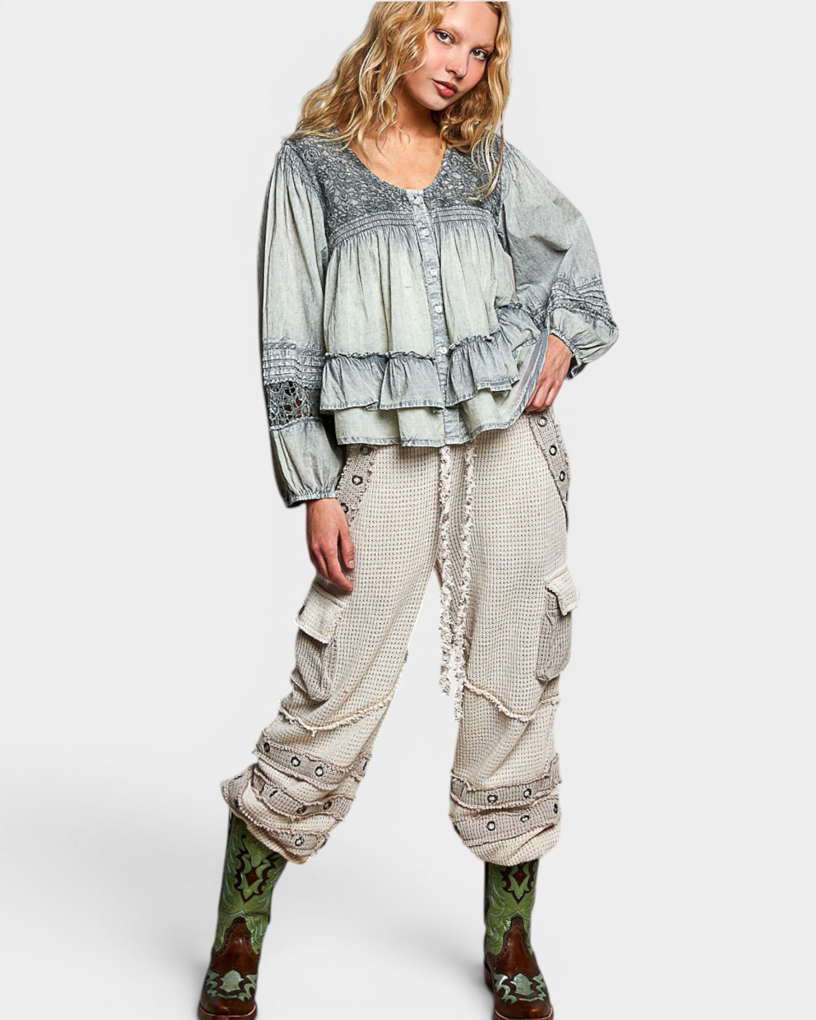 Woman wearing a layered outfit with a top and cargo pants on a white background