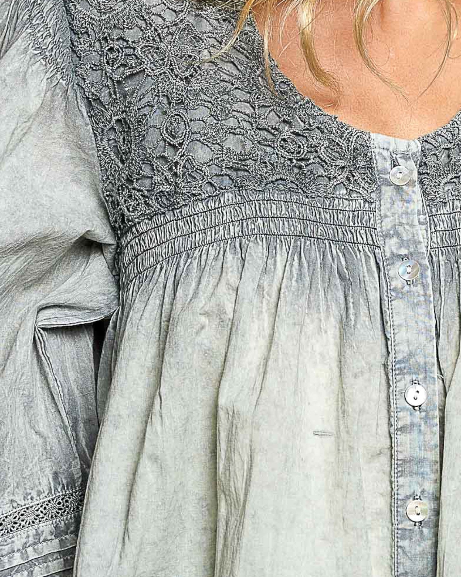 Light blue denim shirt with lace detailing on a person
