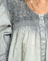 Light blue denim shirt with lace detailing on a person
