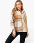 A woman modeling a mixed-media jacket with a beige body, a tan and brown plaid front panel, and a cream plaid collar and cuffs, paired with black pants against a white studio background.