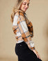 Woman wearing a plaid shirt with a beige background