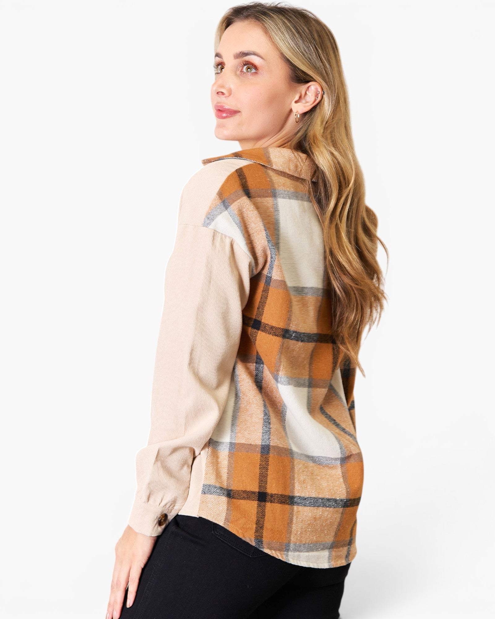 A woman wearing a long-sleeve plaid shirt, shown from a side-back angle against a plain white studio background.