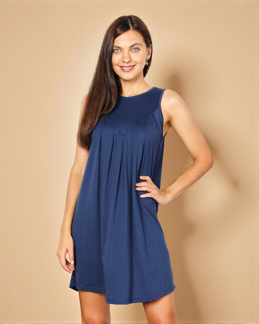 Woman wearing a blue dress against a beige background