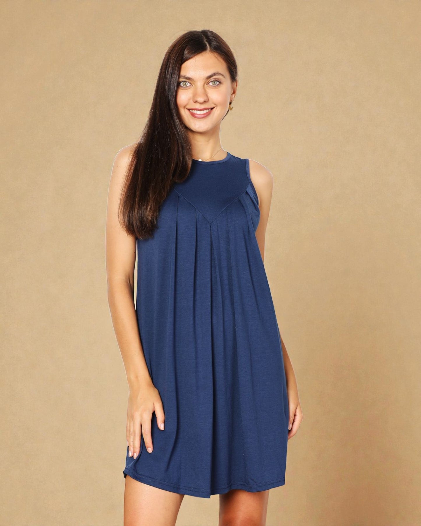 Woman wearing a blue dress against a beige background