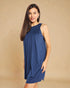 Woman wearing a blue dress against a beige background