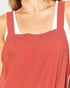 Red apron worn by a person on a white background