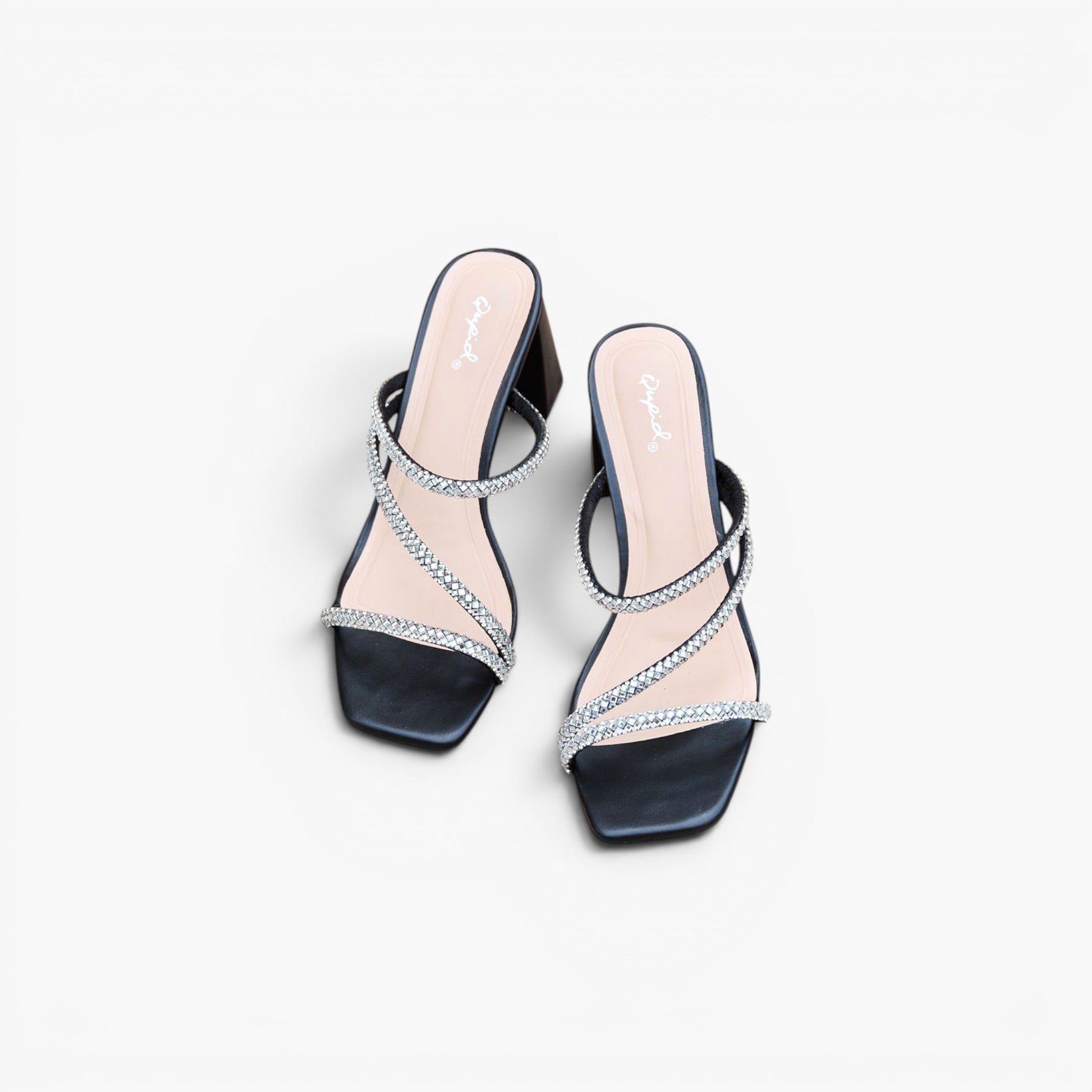 A pair of women's black mule sandals with square toes, featuring criss-crossing straps embellished with silver rhinestones and a chunky black block heel, shown on a light gray background.