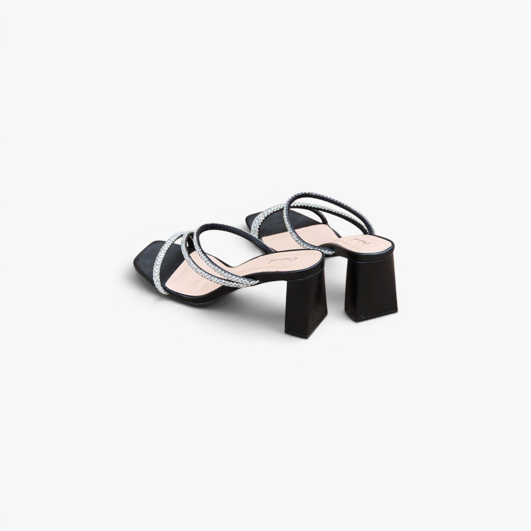 A pair of women's black mule sandals with square toes, featuring criss-crossing straps embellished with silver rhinestones and a chunky black block heel, shown on a light gray background.