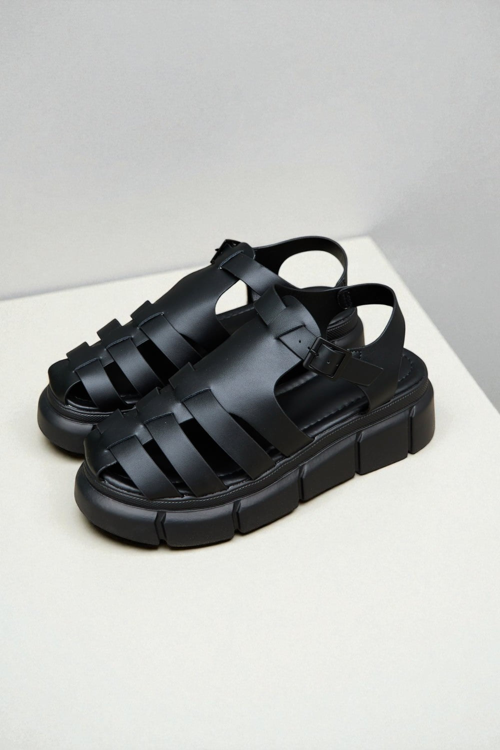 Black sandals on a light gray background