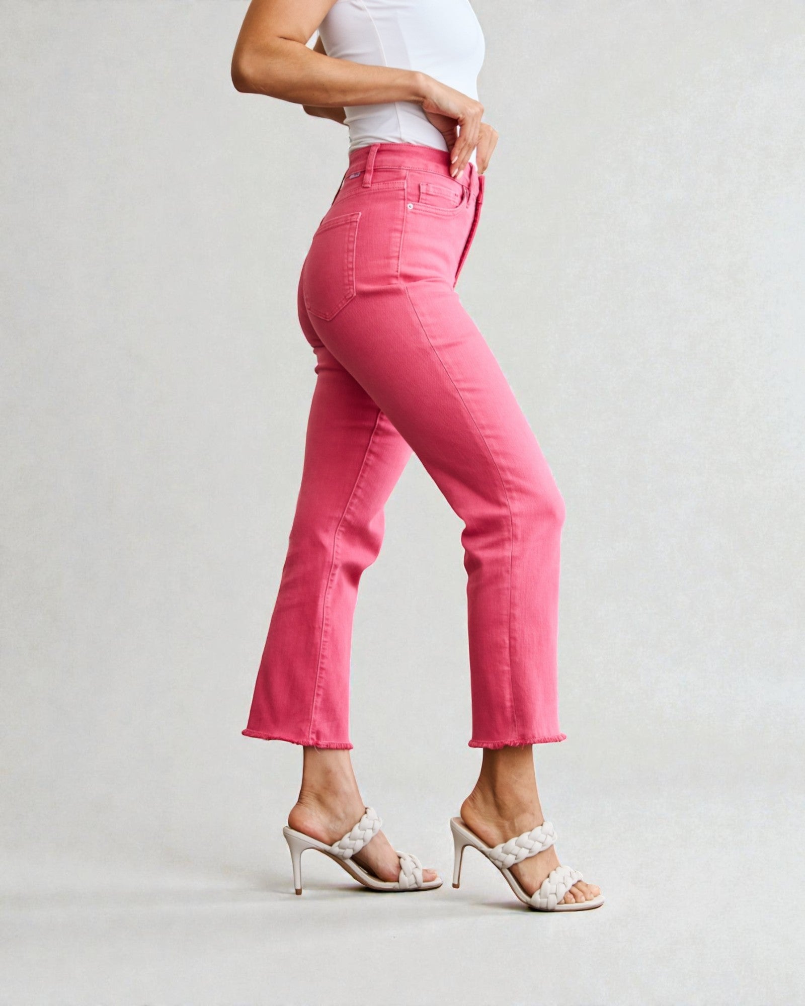 Person wearing bright pink pants on a plain background