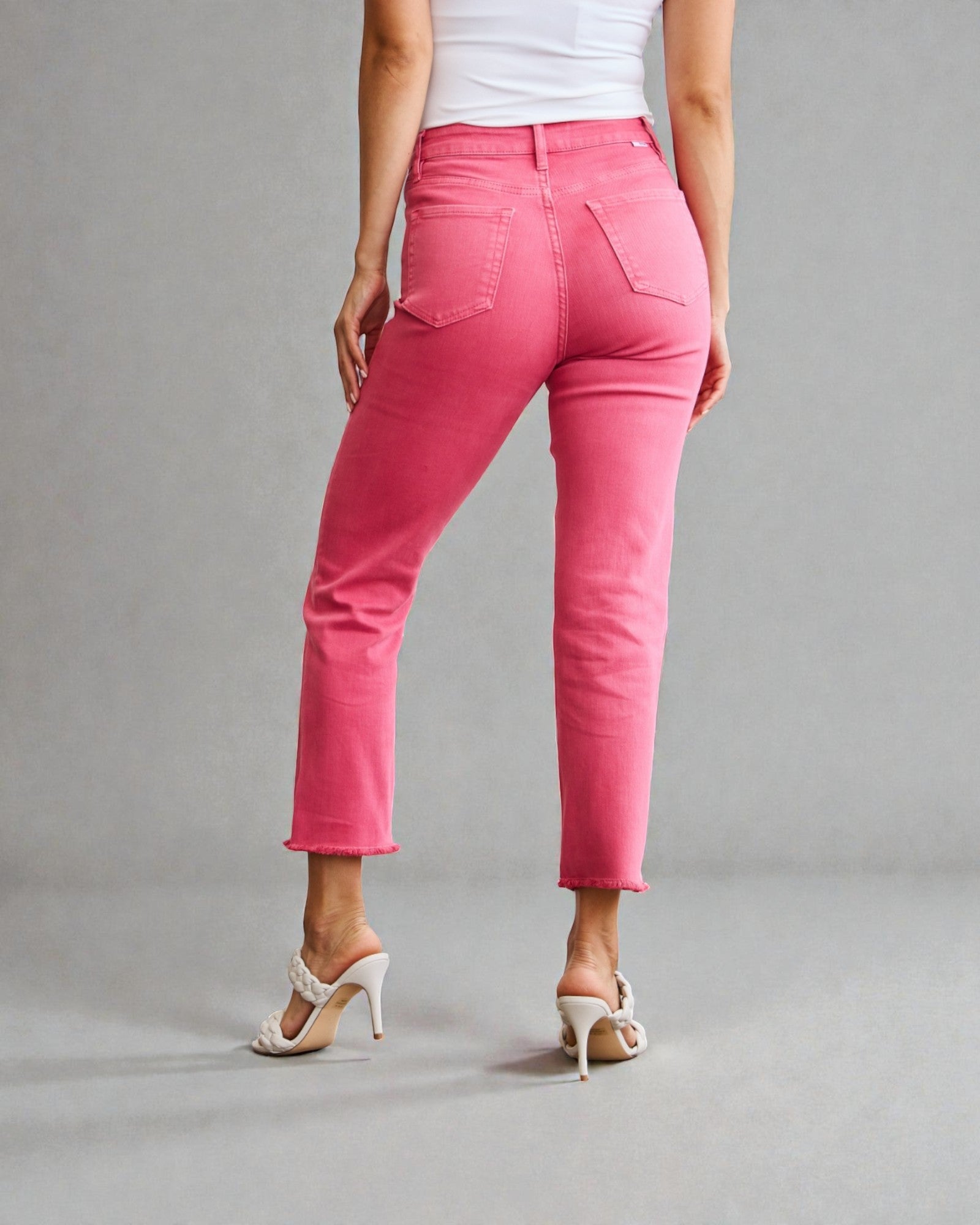 Person wearing bright pink pants on a gray background