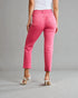 Person wearing bright pink pants on a gray background