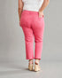 Person wearing pink pants and white top on a gray background