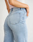 Light blue jeans worn by a person on a plain background