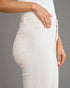 White pants with a brand logo on a gray background