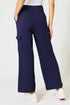 Navy cargo pants worn by a person on a white background
