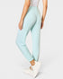 Light blue leggings worn by a person on a white background