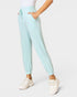 Light blue jogger pants worn by a person on a white background