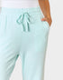 Light blue jogger pants worn by a person on a white background