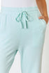 Light blue pants with a drawstring on a plain background
