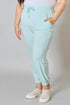 Person wearing light blue jogger pants on a plain background