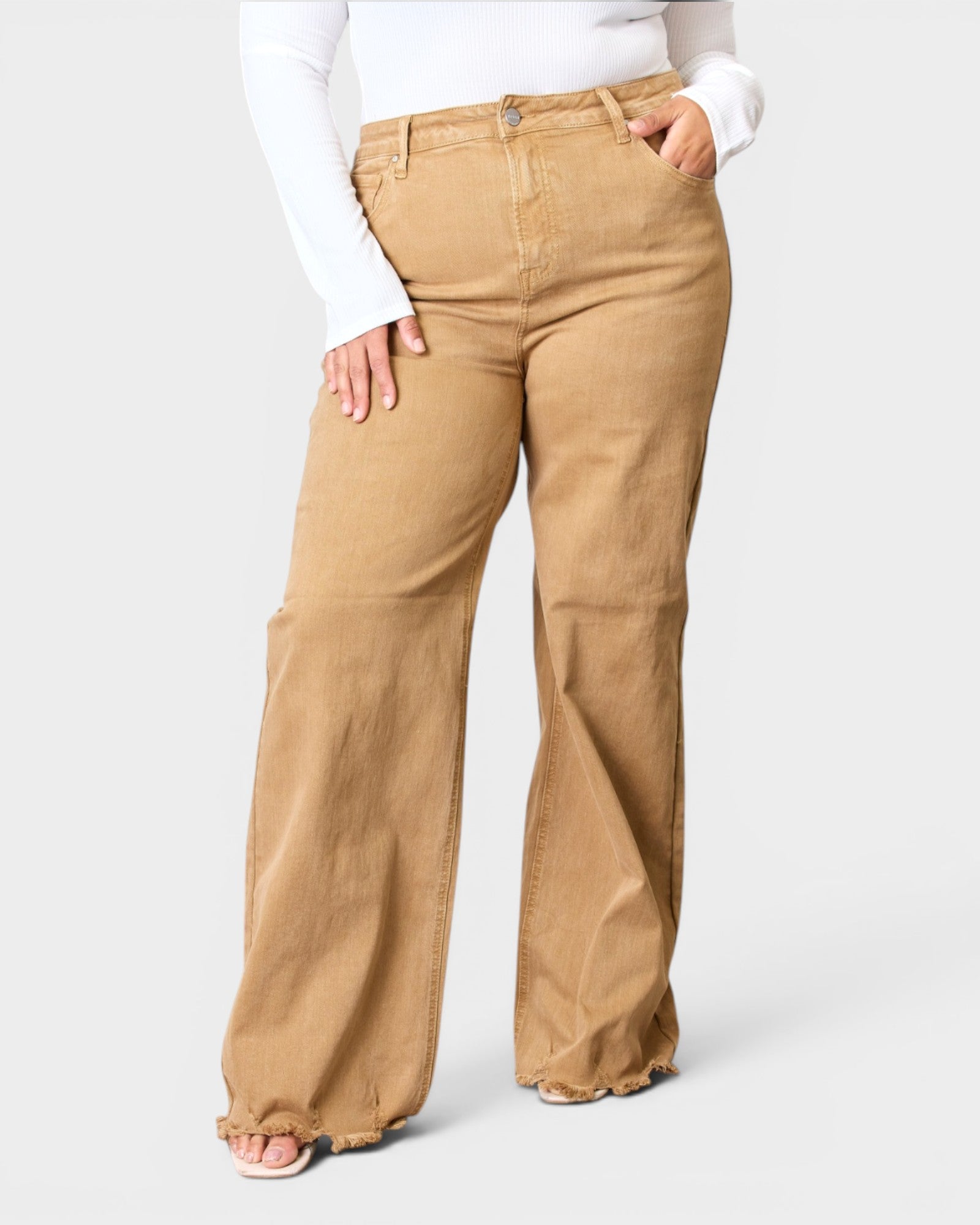 Tan pants worn by a person on a white background