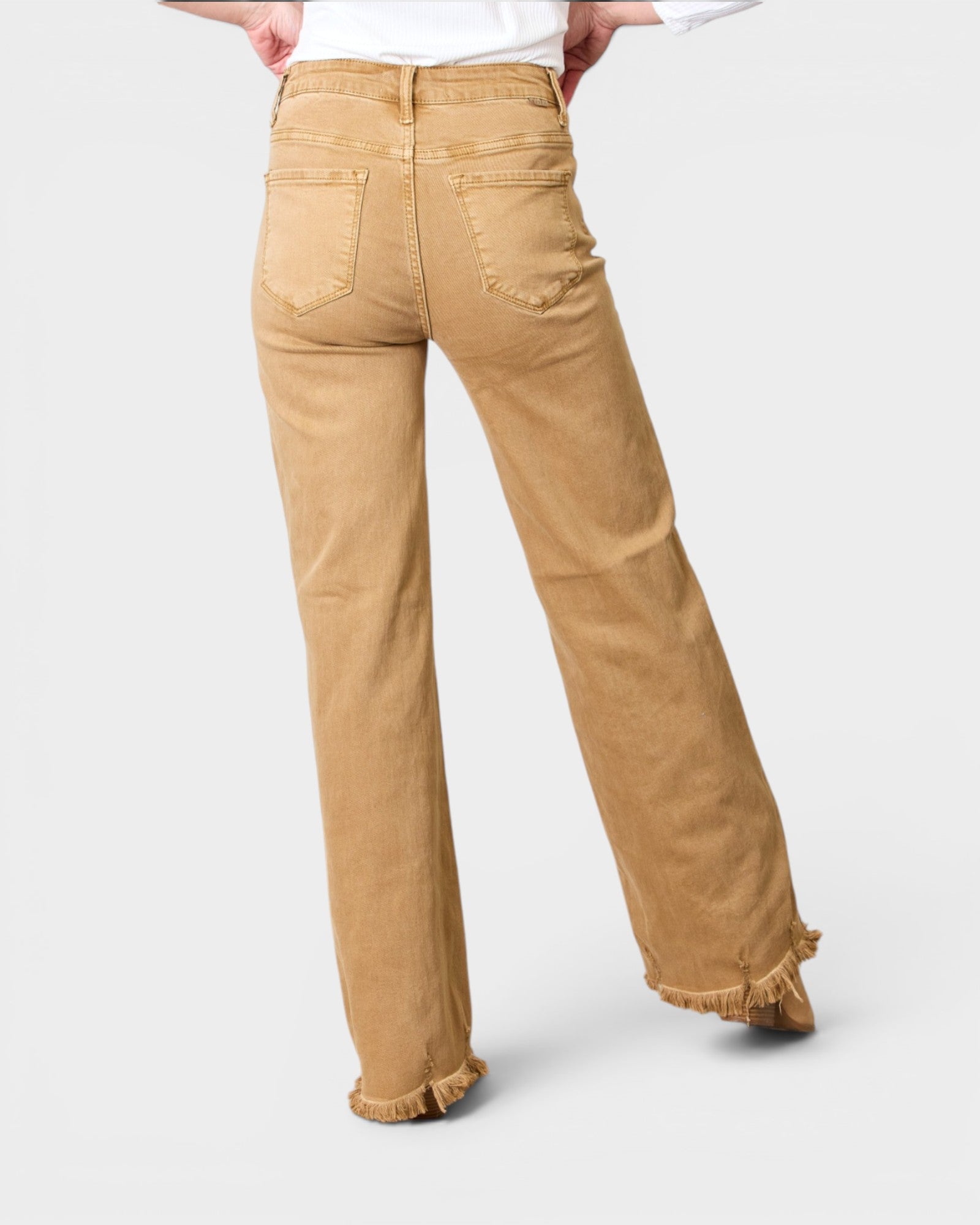 Tan pants worn by a person on a white background