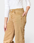 Person wearing tan pants with a white background