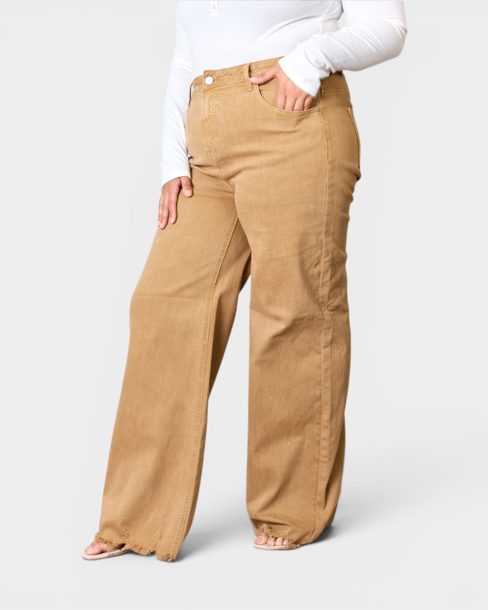 Person wearing tan pants on a white background