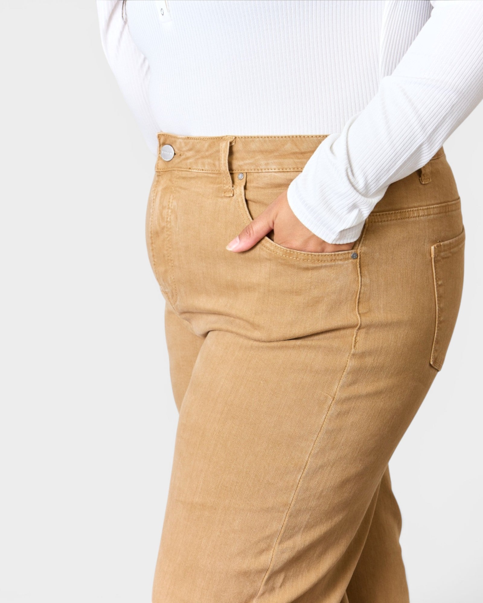 Tan pants worn by a person on a white background
