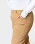 Tan pants worn by a person on a white background