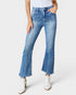 Person wearing blue flared jeans on a white background