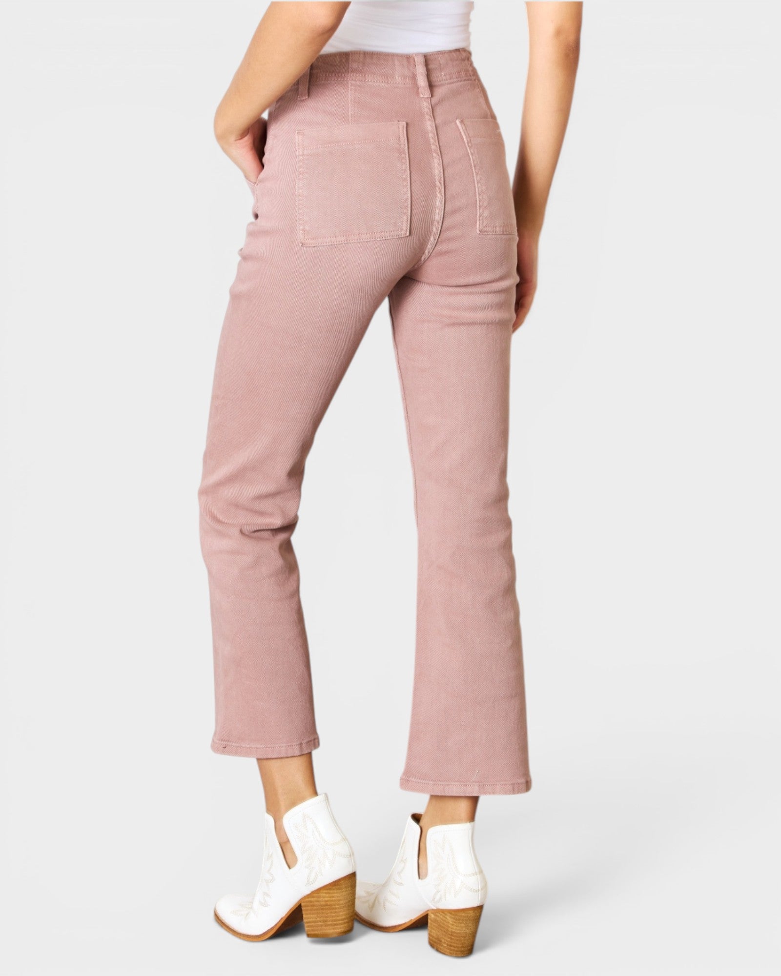 Pink pants worn by a person on a white background