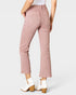 Pink pants worn by a person on a white background