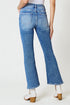 Blue jeans worn by a person on a white background