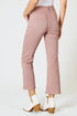 Person wearing pink pants and white shoes on a white background
