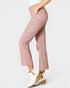 Pink jeans worn by a person on a white background