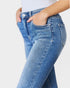 Blue jeans worn by a person on a white background