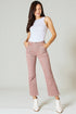 Woman wearing a white sleeveless top and pink pants on a plain background