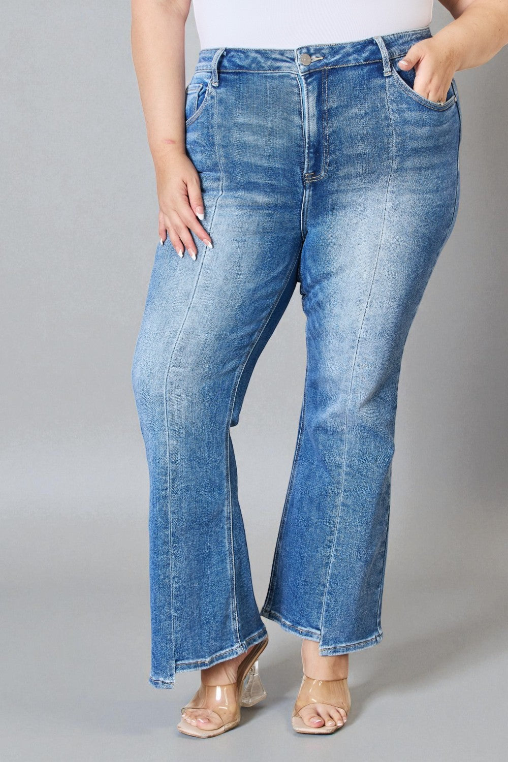 Blue jeans worn by a person on a gray background