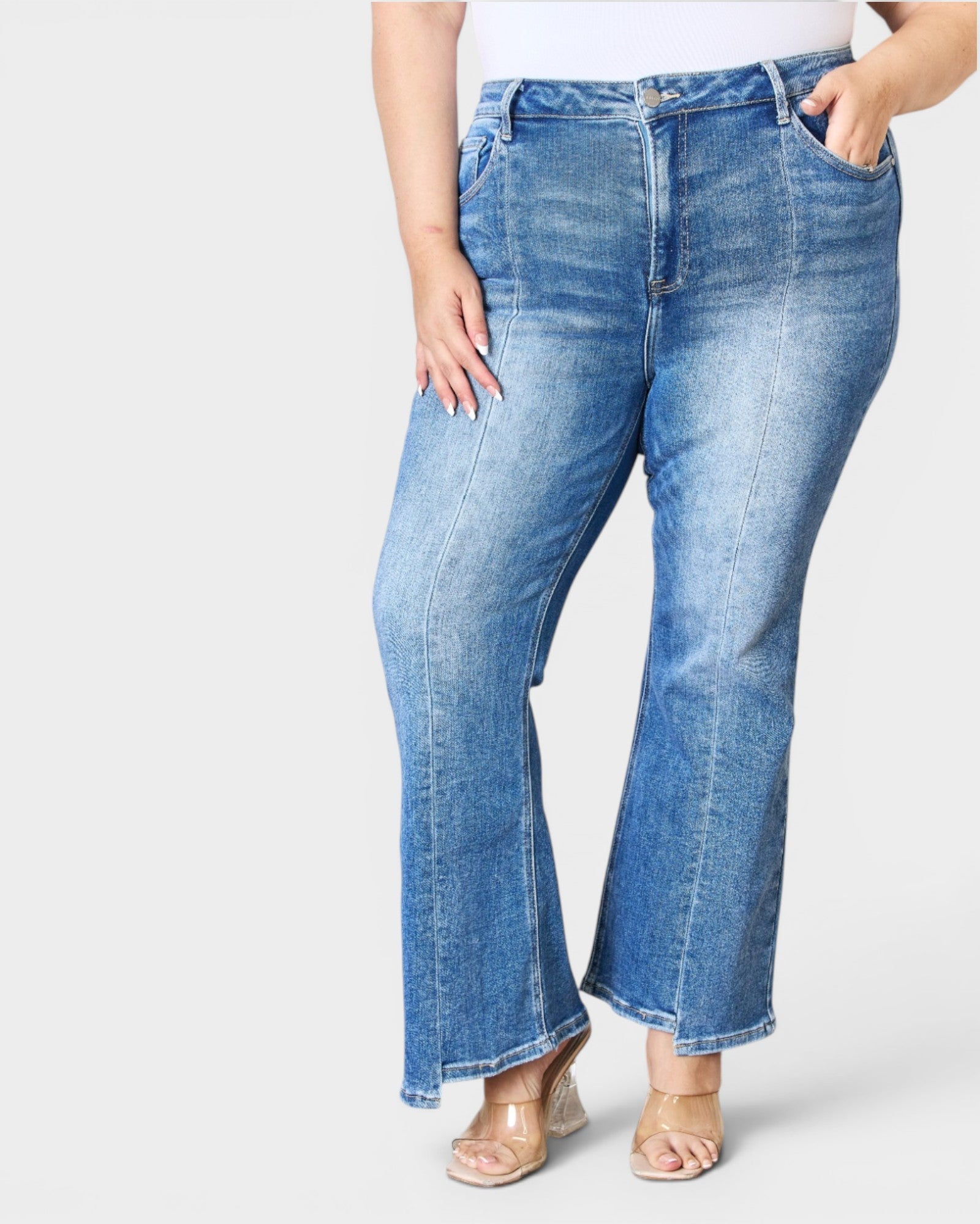 Person wearing blue jeans on a white background