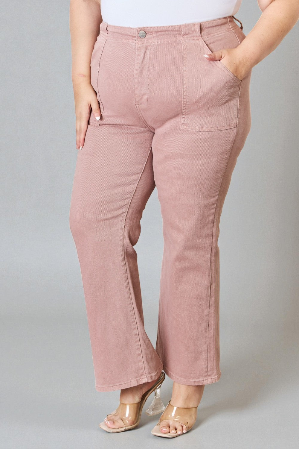 Person wearing pink pants on a gray background